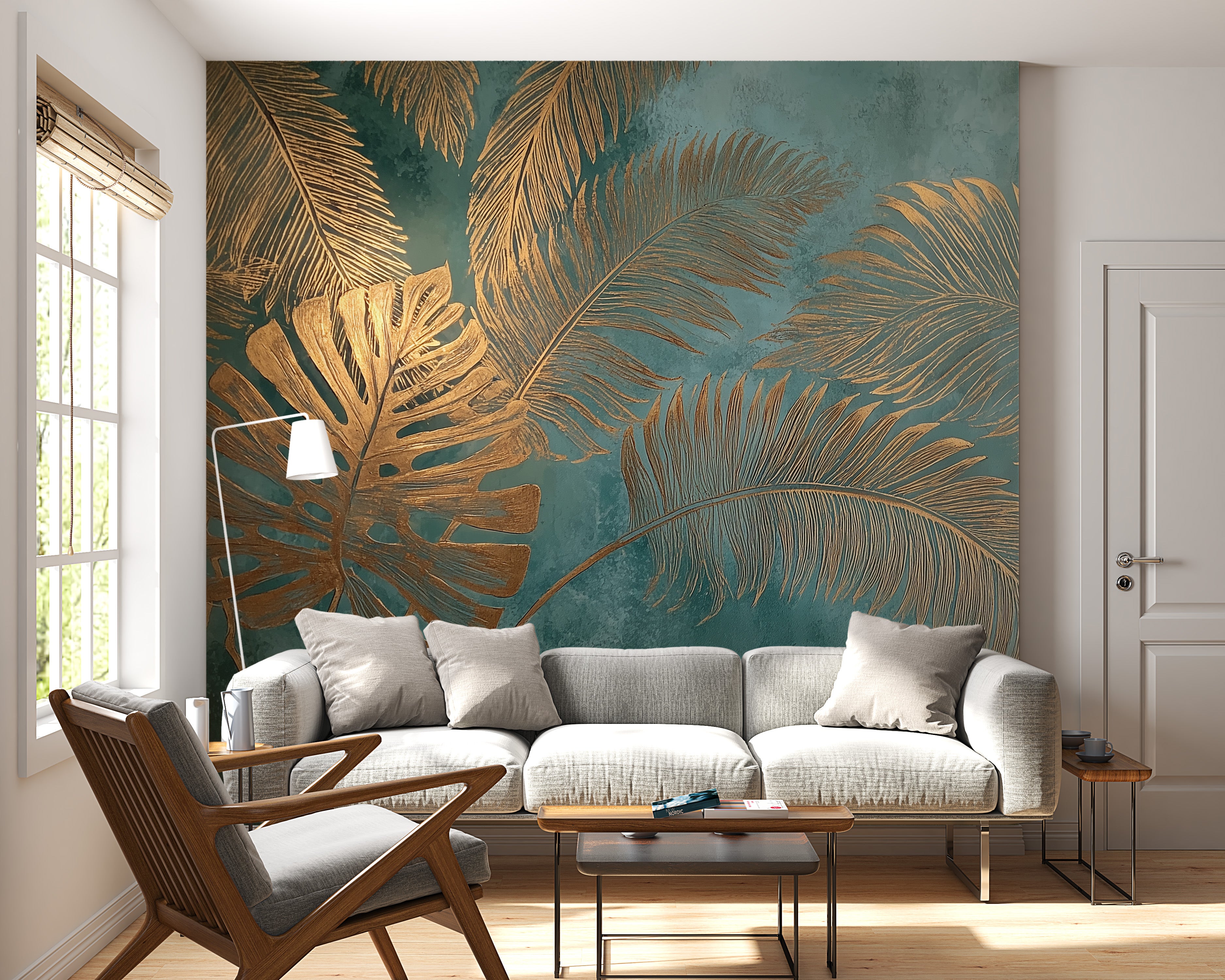 Tropical palm leaves mural with gold fronds on teal background in a living room with a light gray sofa and wooden furniture