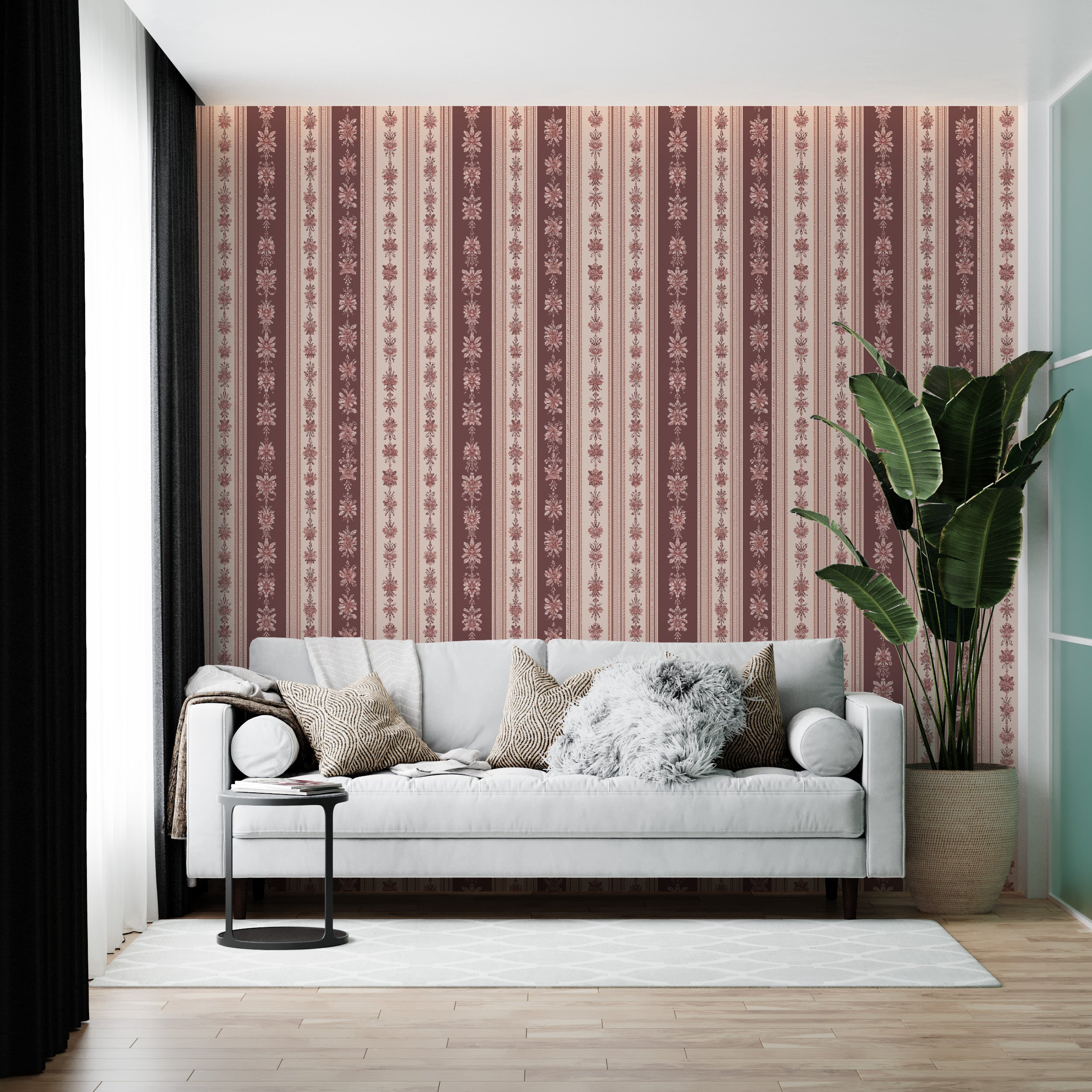Vintage floral striped wallpaper in dusty rose and cream with damask motifs adorning a living room wall behind a white sofa