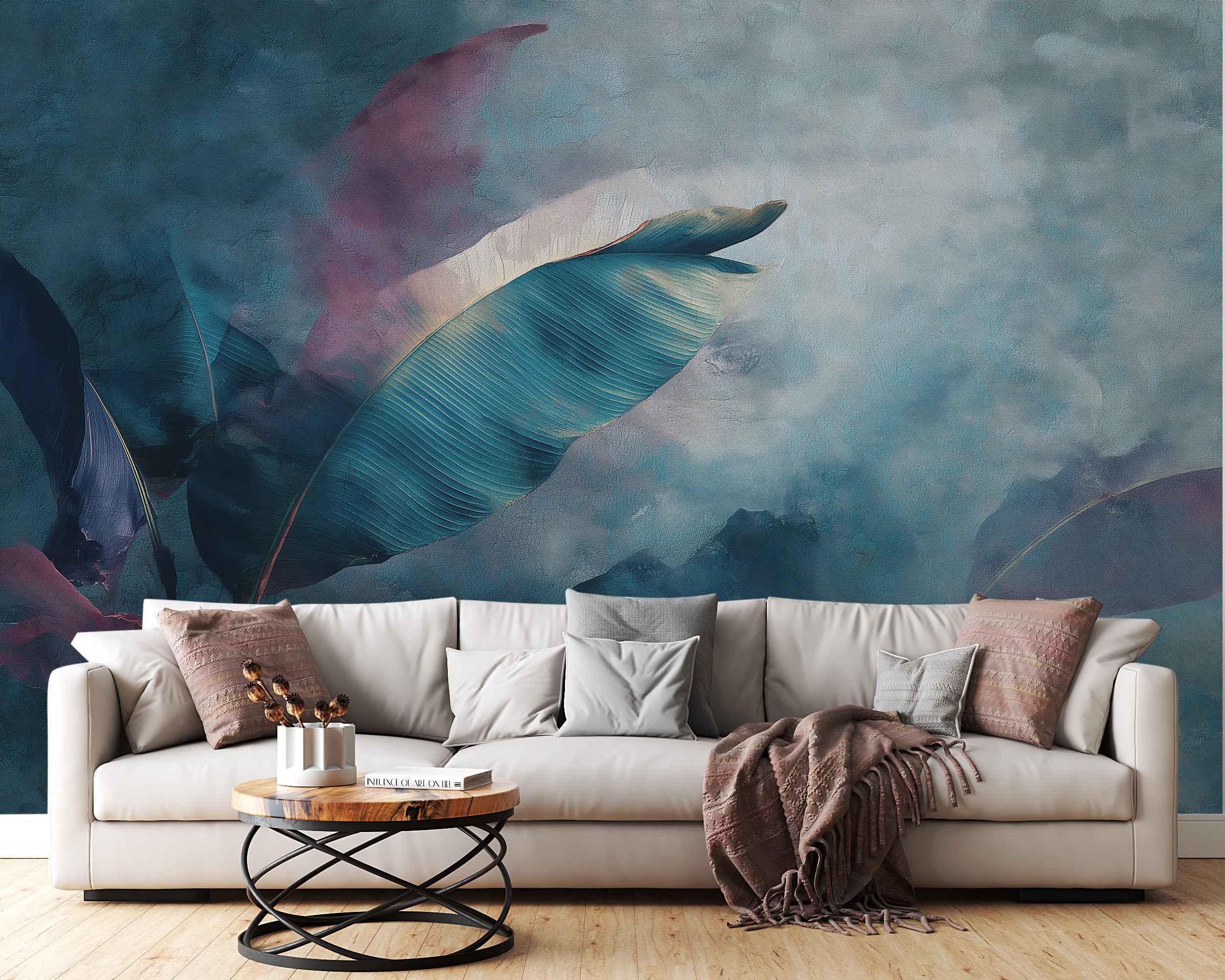 Abstract tropical leaves mural in teal and purple tones behind a neutral beige sofa in a modern living room