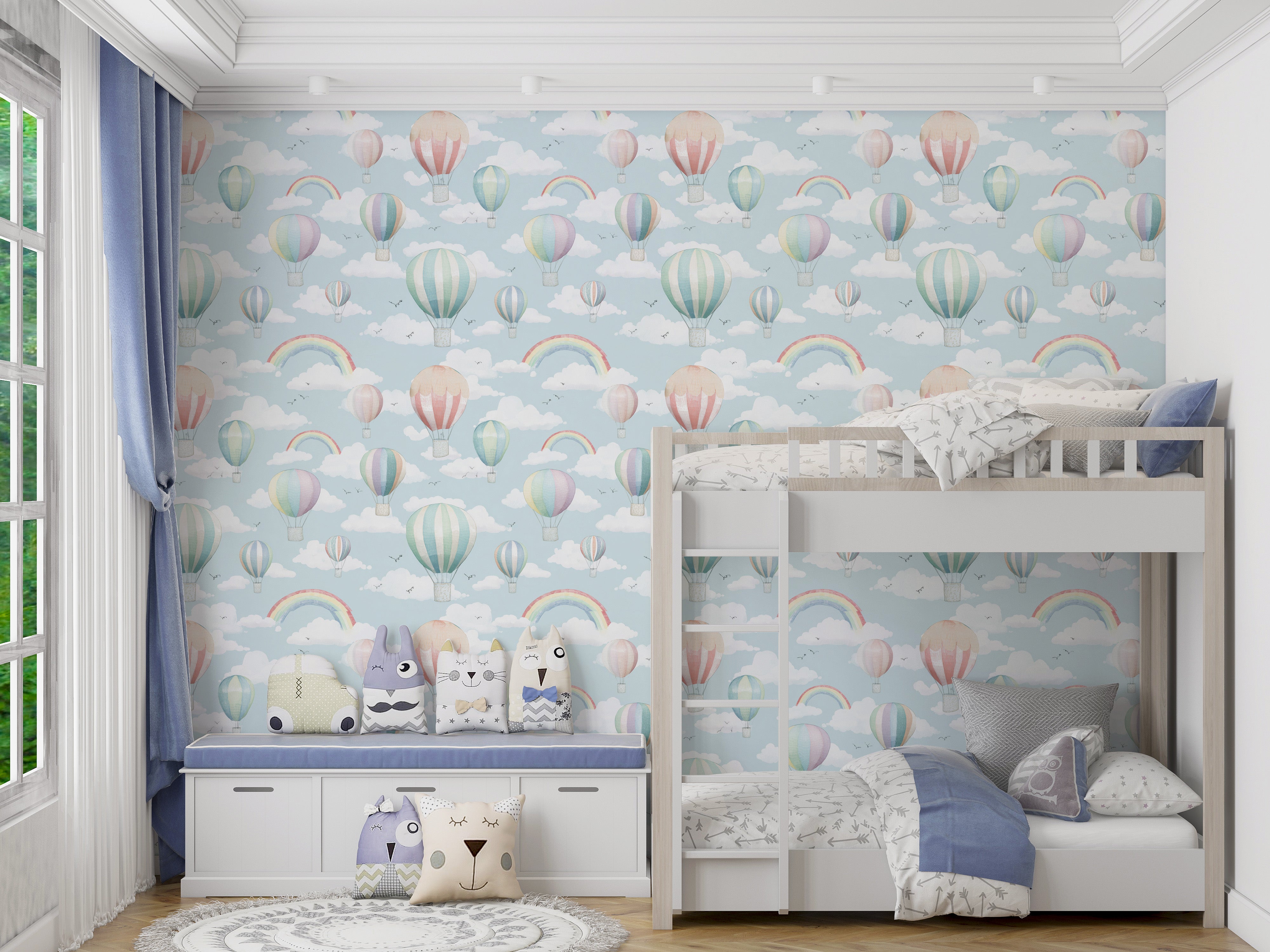 Whimsical blue sky wallpaper with colorful hot air balloons and rainbows in a kid's bedroom featuring a bunk bed