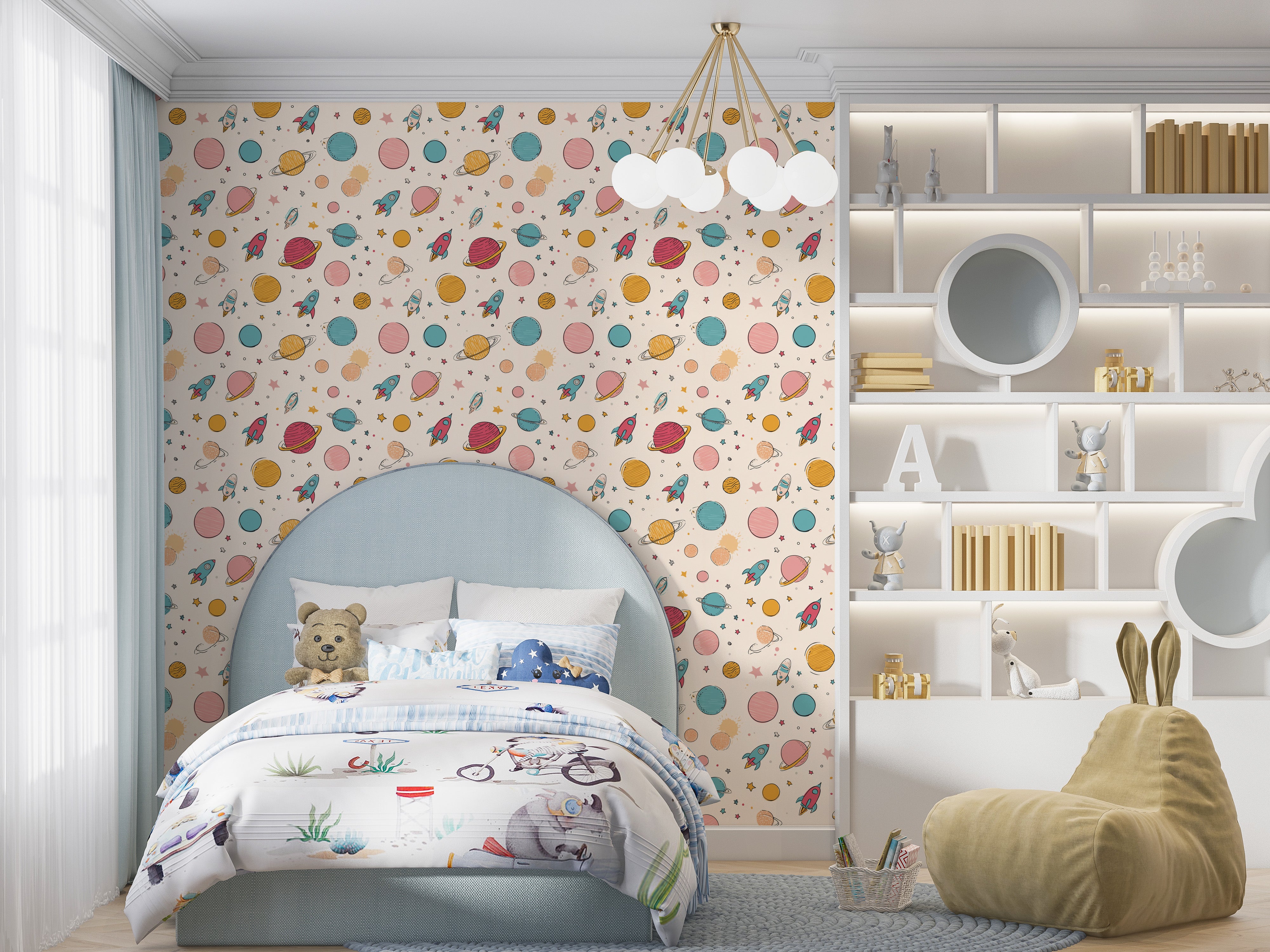 Space adventure wallpaper in pastel with planets rockets stars behind a blue upholstered bed in a kid's room setting with pla