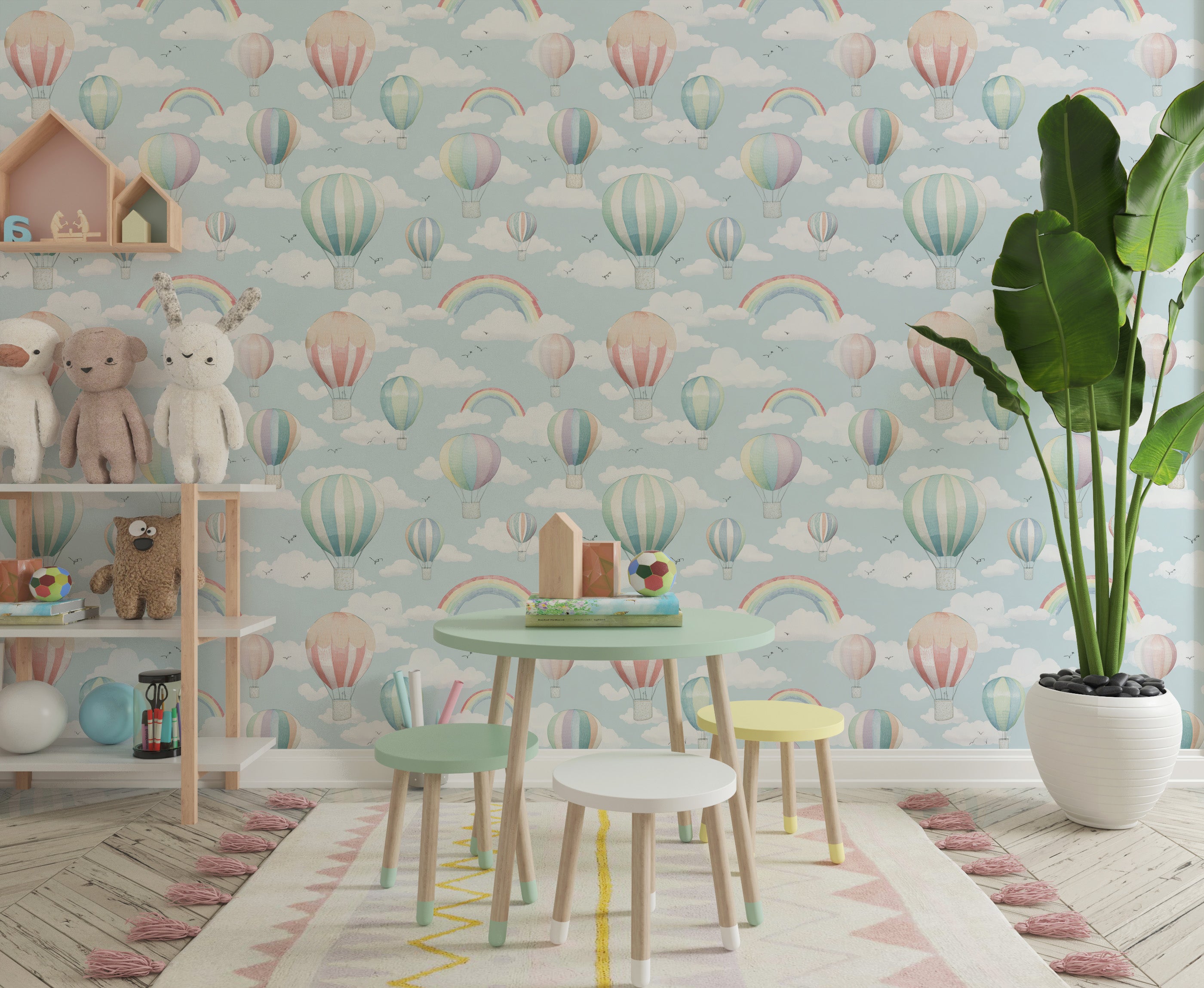 Whimsical nursery scene with pastel hot air balloons and rainbows on sky-blue wallpaper, surrounded by plush toys